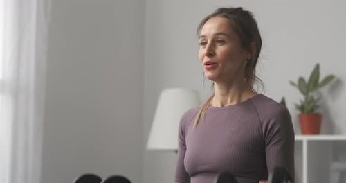 Woman Doing Bicep Curls with Dumbbells Indoors
