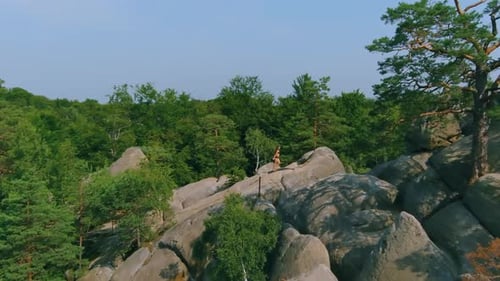 Woman Doing Yoga Poses on Rocky Mountain