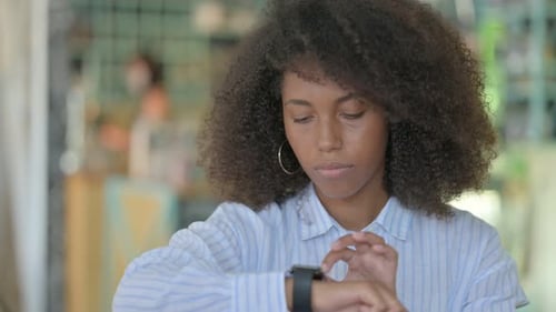 Woman Uses Smartwatch Device Indoors Daytime