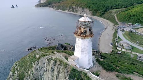 Aerial Closeup View of an Old Lighthouse on the Cliff on Pacific Coast