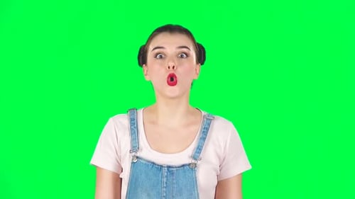 Surprised Girl with Two Hair-buns on Green Screen at Studio, Slow Motion