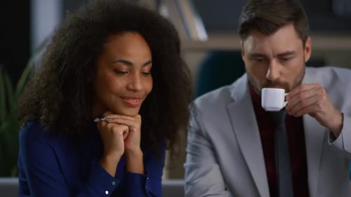 Diverse Business Partners Talking Sharing Ideas Video Calling in Coworking Cafe