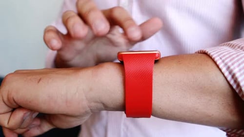 Arm Using Modern Smart Watch With Red Band