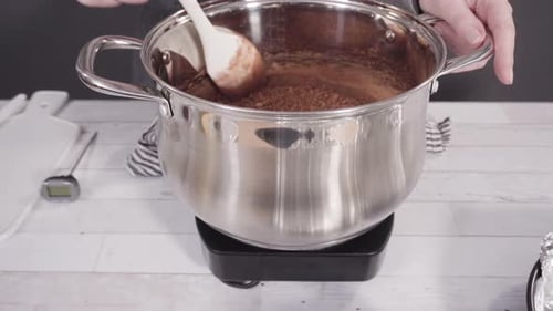Step by step. Mixing ingredients in the cooking pot to make simple chocolate fudge.