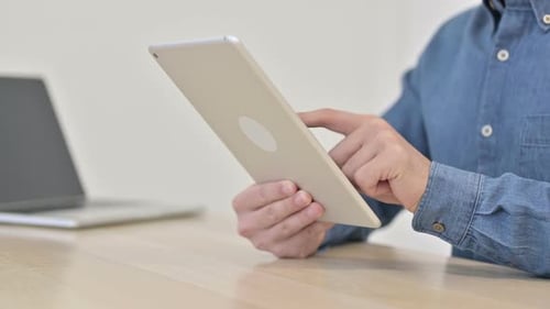 Person Using Tablet in Office Environment