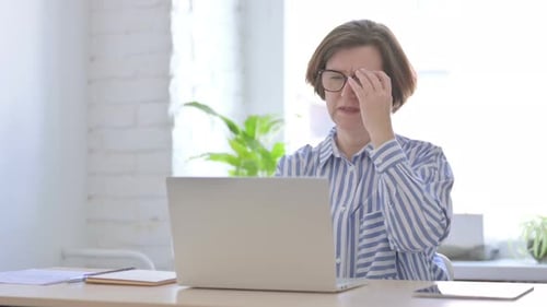 Tired Woman Working at Computer in Office
