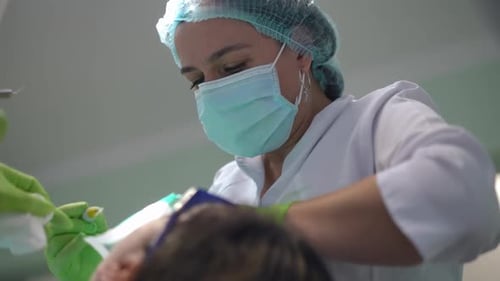 Medical Professional Giving Dental Treatment to Patient