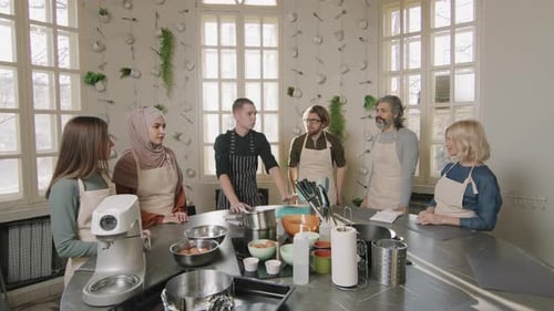 Group Enjoys Fun Baking Class Together Indoors