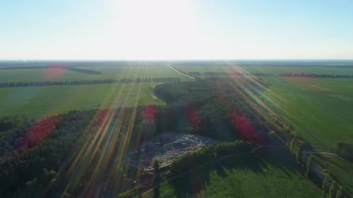Aerial View Huge Rubbish Dump in Summer at Sunset or Sunrise Around the Forest