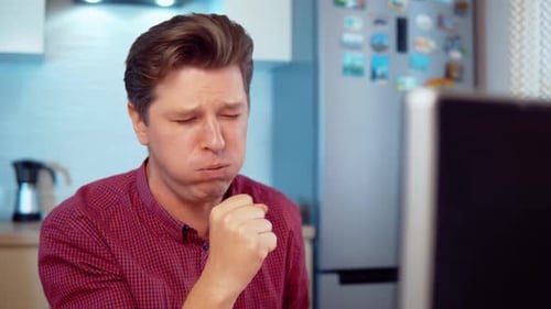 Adult Man Coughing into Fist at Home