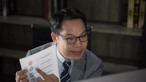 Man on Video Call Discussing Chart