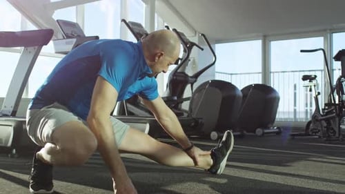 Mature Man Stretching at the Gym