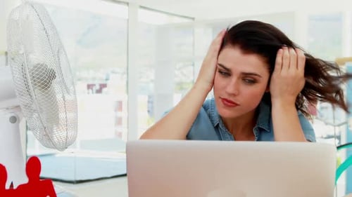 Stressed Young Adult Woman With Laptop and Fan