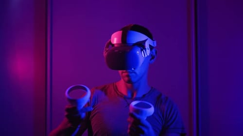 Person Using VR Headset and Remote Controls