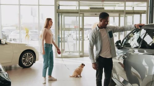 Couple and Dog Buying a Car at Dealership