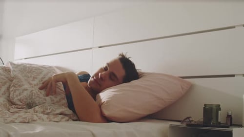 Young Adult Wakes up and Reaches for Phone