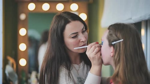 Makeup Artist Applying Makeup to a Woman