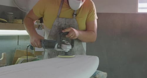 Male surfboard maker in his workshop
