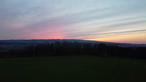 Vibrant Sunset Over a Grassy Field