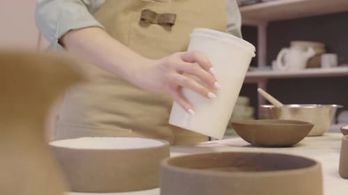 Potter Painting Crockery in Ceramic Workshop