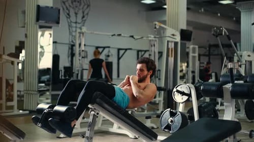 Man Doing Sit Ups in a Gym