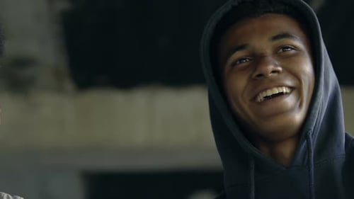 Two Young Men Smiling in Urban Setting