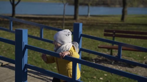 Adorable infant boy at playhouses in public playground, Zagreb, Croatia.