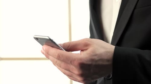 Business Man Using Smartphone in Bright Setting