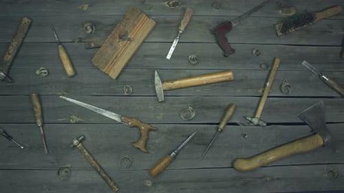 Carpentry tools laid out on wood background