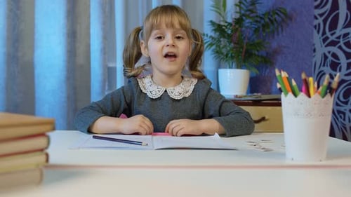 Young Girl Learning at Home and Speaking