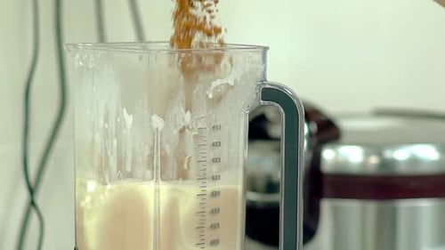 Brown Granules Poured into Blender for Smoothie