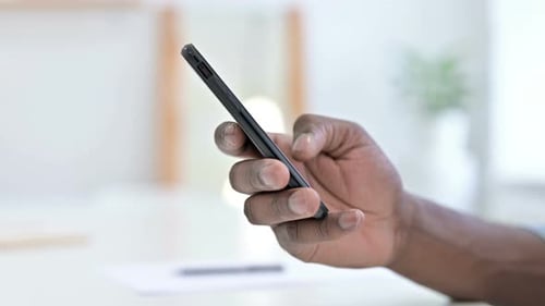 Close Up Young African Man Hand Using Smartphone