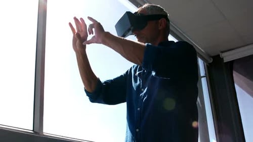 Man Interacting with Virtual Reality Headset in Office