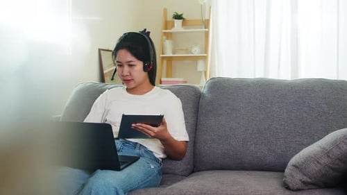 Young Woman Working Remotely on Laptop and Tablet