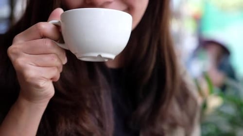 Young Woman Enjoying Coffee in a Cafe