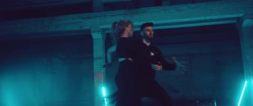 Young Couple Dancing in Dark Urban Neon Environment