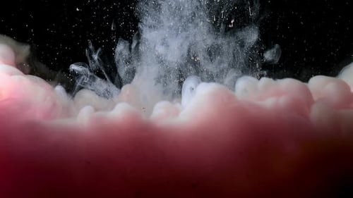 Rose Pink Fluid Pearl Paint Is Melting in the Water on Black Background