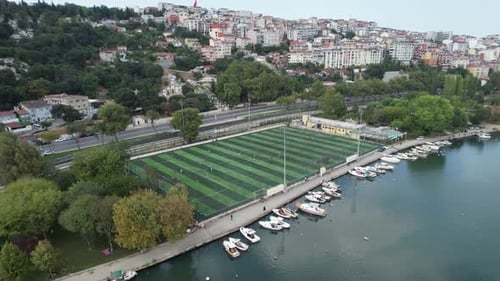 Aerial View of Soccer Game Near City and Bay