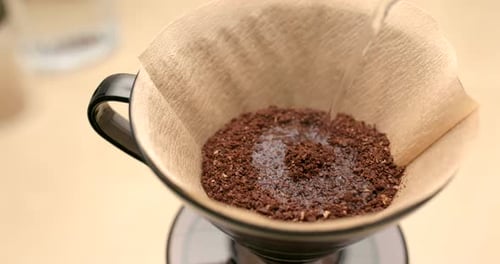 Pouring Water Over Coffee Grounds Close Up