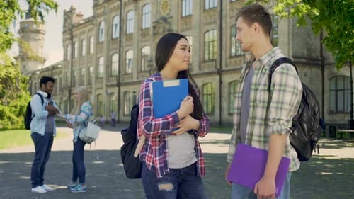 Couple of Classmates Communicating in University Courtyard During Break Friends