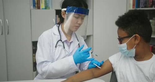 Doctor Giving Vaccine Shot to a Child