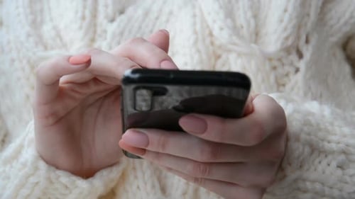 Close Up Front View Young Woman Typing Message on Mobile