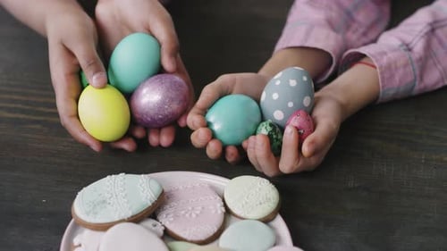 Close Up of Kids with Easter Eggs and Cookies