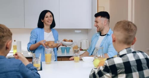 Happy Family Enjoying Breakfast Together at Home