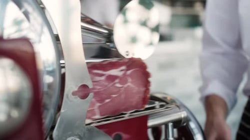 Chef Slicing Meat With Slicing Machine