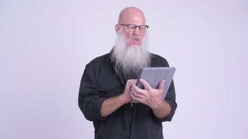 Man with Beard Using Tablet