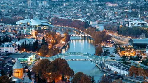 Tbilisi, Georgia. Top View Of Famous Landmarks In Night Illuminations. Georgian Capital Skyline