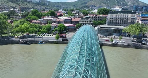 Aerial view of Tbilisi city central park and Bridge of Peace. Beautiful cityscape of old Tbilisi at