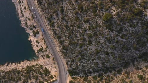 Aerial View of Highway Road Along Mountains and Blue Ocean