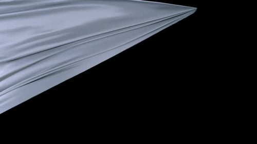 Silvery Gray Fabric Flowing Against Black Background